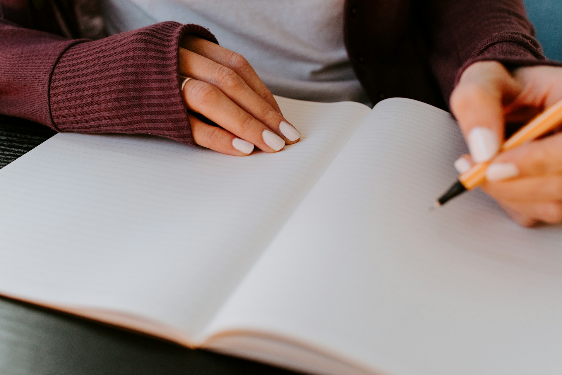 female writing on a piece of paper